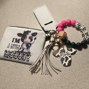 Black-and-white cow printed beaded wristlet with accessories ￼